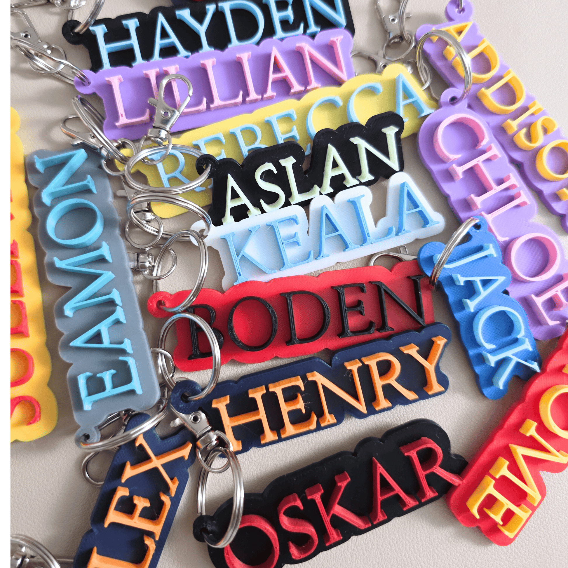 Colorful keychains with personalized names on a light background