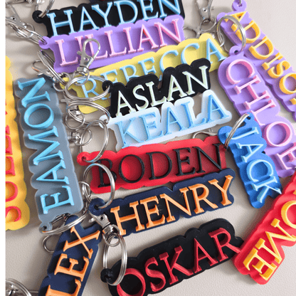 Colorful keychains with personalized names on a light background