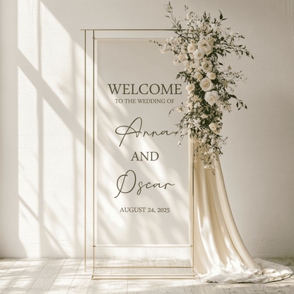 Wedding welcome arch with floral decorations and personalized text on a fabric linen sign