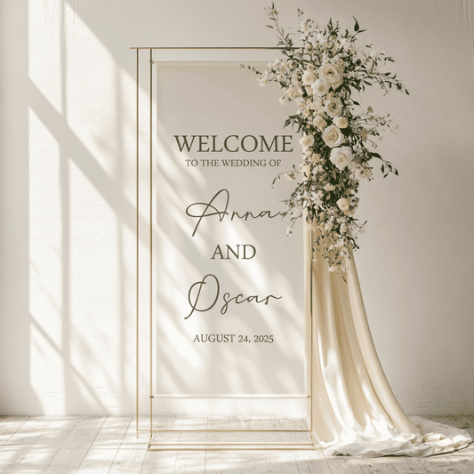 Wedding welcome arch with floral decorations and personalized text on a fabric linen sign